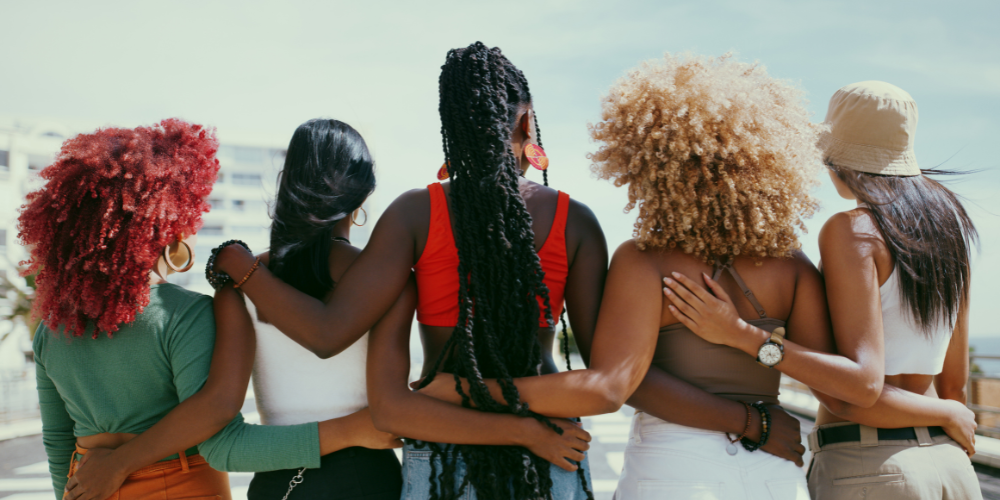 Women on beach with a mix of hair types