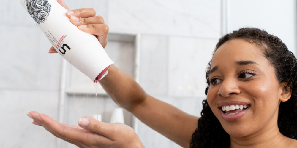 Women Holding Anti-Residue Cleanse In Shower