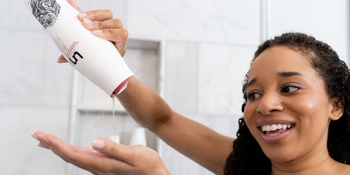 Women Holding Anti-Residue Cleanse In Shower