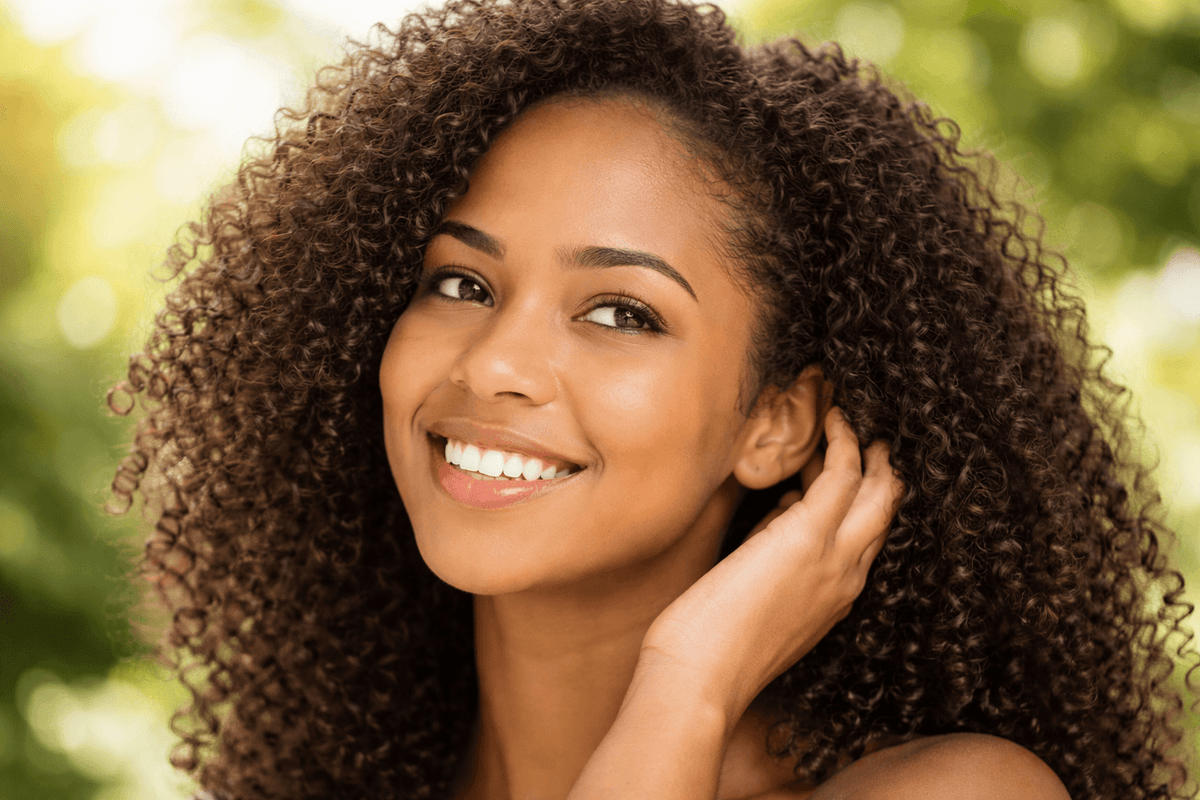 woman with soft, shiny curly hair in natural sunlight
