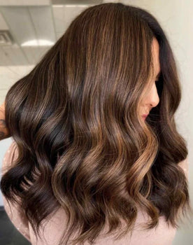 woman with soft healthy hair showing results of a healthy hair routine