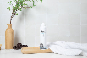clean minimal flat lay background with soft shadows and hair care styling tools on white surface